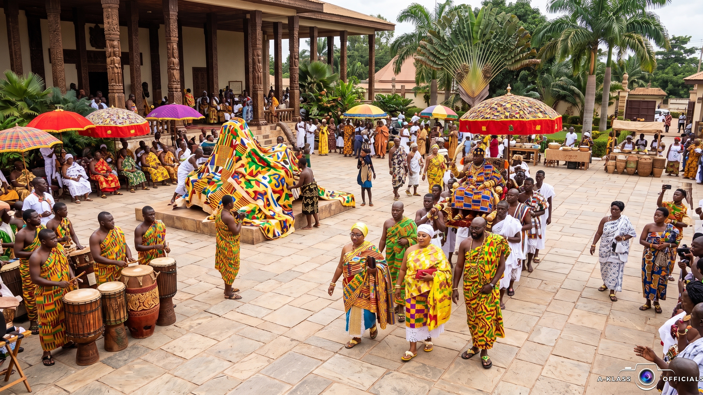 Community members in kente cloth gather at a traditional Asante durbar, with royal umbrellas, drummers and elders.